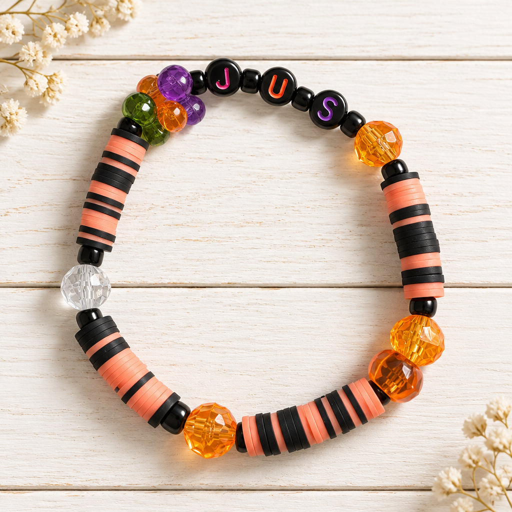 Halloween bracelet that is black and orange on a white background. 