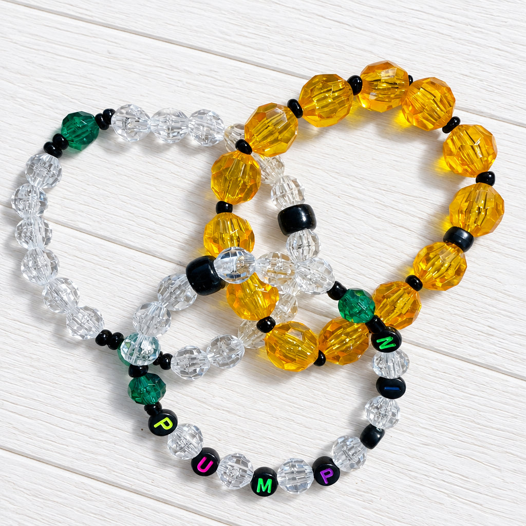 3 bracelets with "pumpkin" written on one—for Halloween 