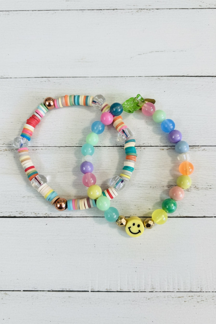 Two beaded bracelets with colorful round beads and a small yellow smiley face charm