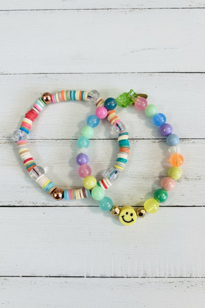Two beaded bracelets with colorful round beads and a small yellow smiley face charm