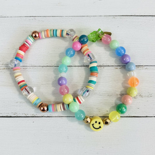Two beaded bracelets with colorful round beads and a small yellow smiley face charm